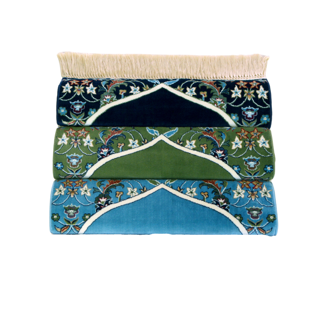Three Imam Al Haram prayer mats displayed together: dark blue, green, and sky blue, each featuring intricate patterns and rich textures.