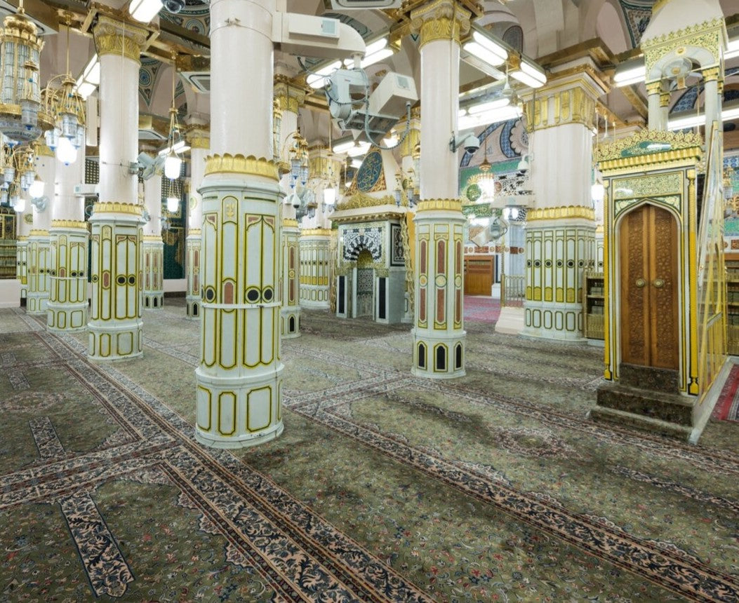 A view of the Rawdah, featuring its beautifully ornate decorations, soft green carpets, and the serene atmosphere within the Masjid an-Nabawi