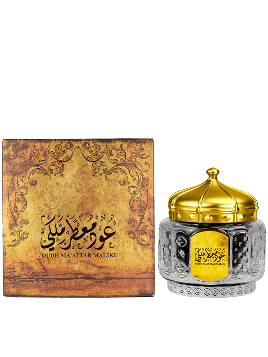 Bottle of Oud Ma'attar Maliki with ornate design and golden accent, presented in a box adorned with intricate, vintage designs.